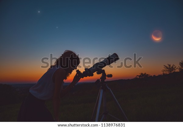 Girl looking at lunar eclipse through a telescope.\
My astronomy work.