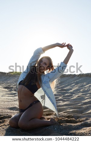 Similar – Young woman standing with closed eyes at the Baltic Sea beach