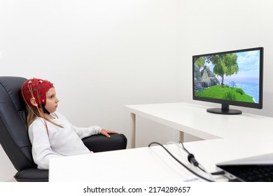 Girl Looking To A Screen While Sitting On A Chair During A Biofeedback Therapy