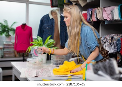 The girl is looking for suitable accessories for the chosen yellow fabric. - Shutterstock ID 2187136765