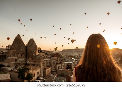 Girl Looking At Sunrise With Hot Air Balloons Over Cappadocia