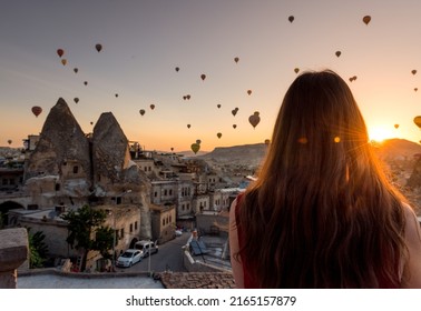 Girl Looking At Sunrise With Hot Air Balloons Over Cappadocia