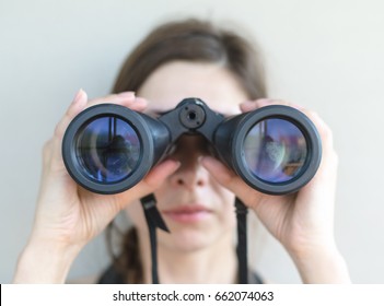 Girl Looking Through The Binoculars.