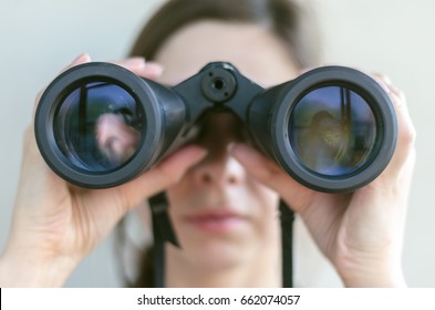 Girl looking through the binoculars. Find and search concept. - Shutterstock ID 662074057
