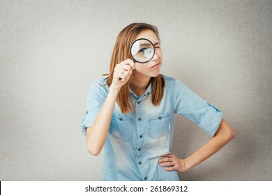 girl looking through a magnifying glass