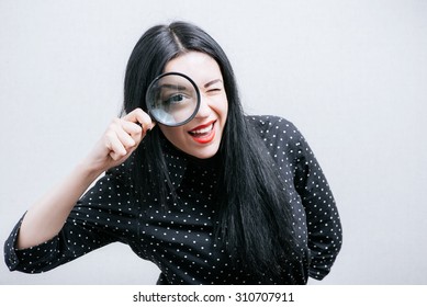 Girl Looking Through A Magnifying Glass