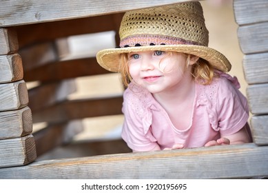 Girl Looking Through Playhouse Window