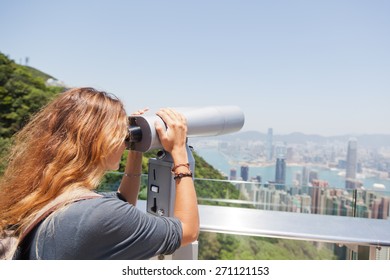 Girl Looking Through A Telescope At The Hong Kong From Victoria Peak