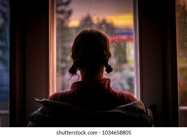 Girl looking from window