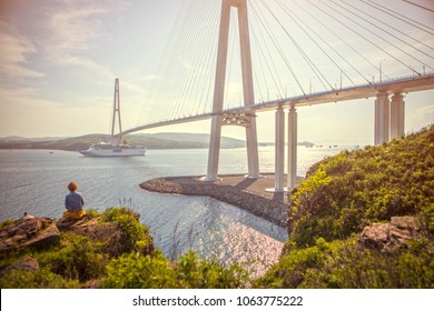 Girl  Looks At  The Cruise Liner Passing Under Russky Bridge 