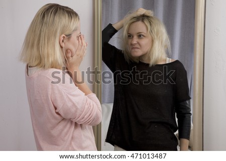 girl looks at herself in the mirror, sees himself in another reflection. The Dark Side, bipolar disorder, dissociative disorder