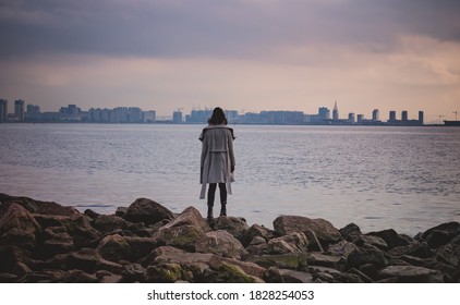 a girl looks at the landscape on the Bay.City in the distance