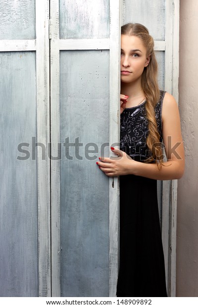 Girl Looks Out Behind Cabinet Door Stock Photo Edit Now 148909892