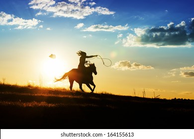 Girl Loses Hat While Riding Horse At Sunset