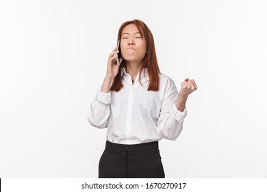 Girl Losing Her Patience Trying Calm Down As Feeling Angry And Annoyed, Clench Fist Bothered, Grimacing Suck Lips From Irritation, Close Eyes, Having Phone Conversation, White Background