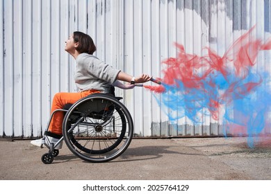 Girl with loss of leg function moving herself at the wheelchair and smiling - Powered by Shutterstock