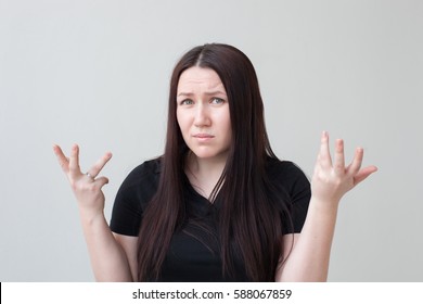 Girl At A Loss Spreads His Arms. Not To Understand The Current Situation