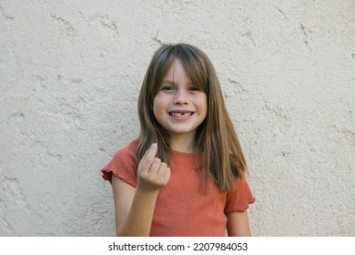 Girl Lost First Tooth Holding It In Her Hand