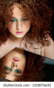 A Girl With Lush Curly Red Hair. Looking In The Mirror. Mystery, A Premonition Of The Future. His Reflection. Look Inside Yourself. Selfknowledge