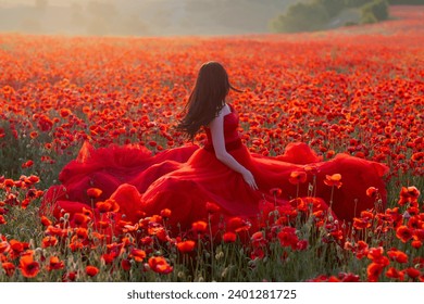 a girl in a lush red dress runs through a large beautiful poppy field