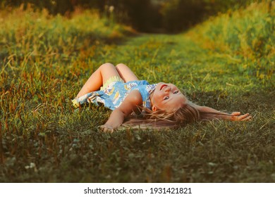 The Girl Is Lying On The Green Grass