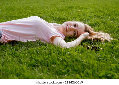 Young Girl Lying On Grass Stock Photo (Edit Now) 706109398