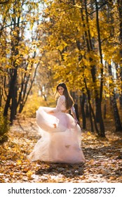 Girl In Magnificent Beautiful Wedding Dress On The Alley In The Autumn Yellow Forest