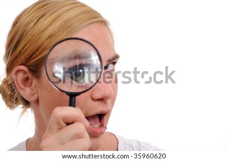 girl with magnifier loupe reviewing  something