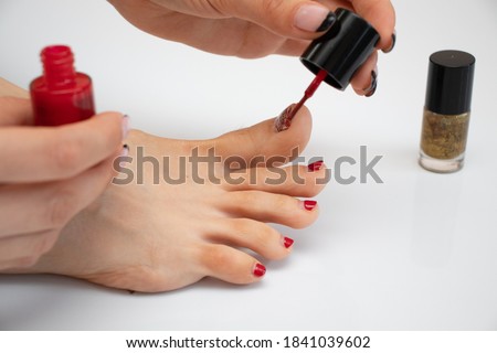 girl makes a pedicure. girl paints her toenails. woman makes new pedicure.the process of applying pedicure