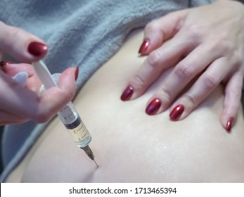 The Girl Makes A Therapeutic Injection With A Syringe In The Buttock