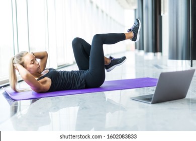 Girl Makes Yoga Exercise Online With Laptop At Gym