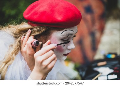 The Girl With Makeup Of The Mime. Improvisation. Suit For Halloween. Mime Shows Different Emotions. Sad Clown. A Female Mime Comedian Portrays Painting Her Face.