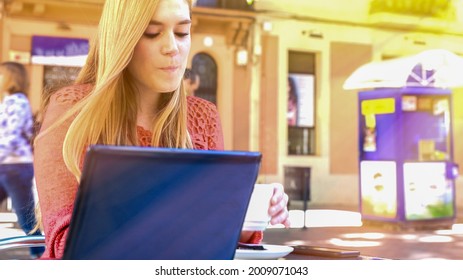 Girl Making Breakfast Seated On A Table Outdoor.