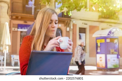 Girl Making Breakfast Seated On A Table Outdoor.