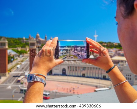 girl making photo with samsung galaxy s7 cell phone from barcelona penthouse