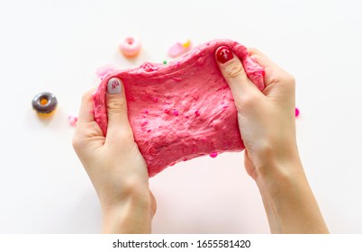 A Girl Making Pink Slime With Charms Herself. Child Making Slime.