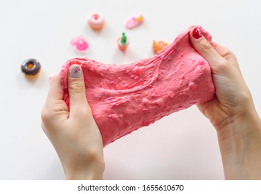 A Girl Making Pink Slime With Charms Herself. Child Making Slime.