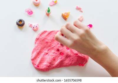 A Girl Making Pink Slime With Charms Herself. Child Making Slime.