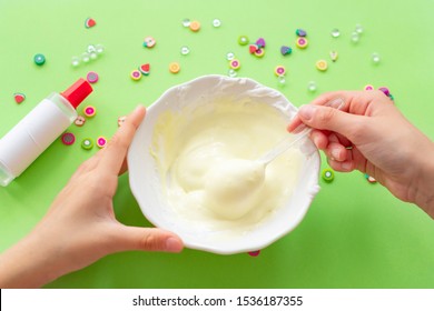 A Girl Making Slime Herself. Child Making Slime On Green Background. 