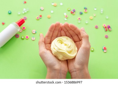 A Girl Making Slime Herself. Child Making Slime On Green Background. 