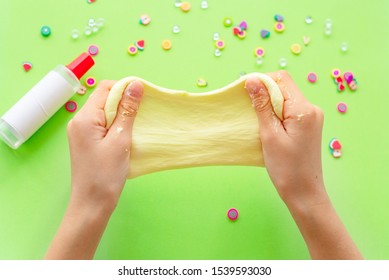 A Girl Making Slime Herself. Child Making Slime On Green Background. 