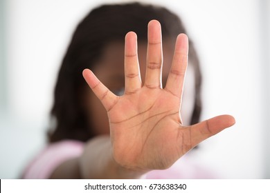 Girl Making Stop Sign On Defocused Background