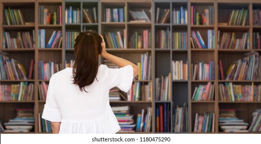 Girl making stressful gesture, standing in front of bookshelves 
