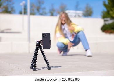 Girl making video of herself on mobile phone