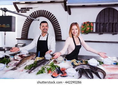 Girl And Man Selling Fish At The Fish Shop