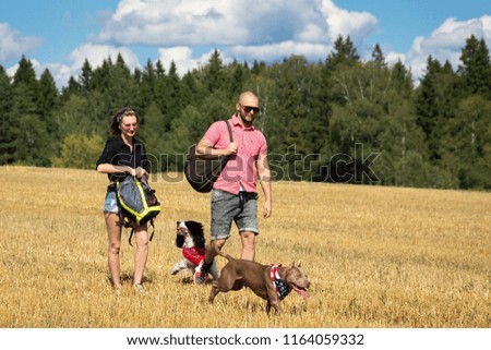 the girl and the man are traveling with a dog