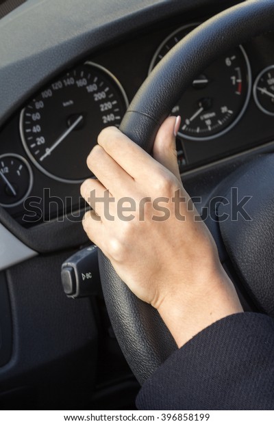 the girl with the manicure keeps hands on the\
steering wheel of the car