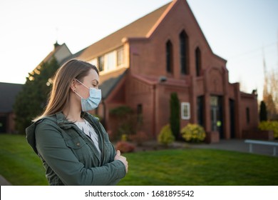 Girl In A Mask On The Background Of An Empty Street In The USA Coronavirus. Against The Background Of Church, Crown Virus, Flash. Faith And Religion. For News And Media