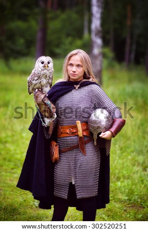 girl in medieval armor, holding an owl
