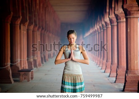 girl meditates hands folded in namaste